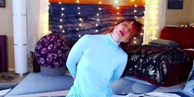 Redheaded babe is practicing yoga in front of the cam