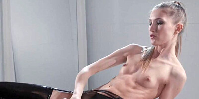 Solo latex doll Mia Reese is posing while wearing a big strapon