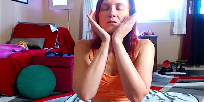 Redheaded chick is flashing and posing in front of the cam