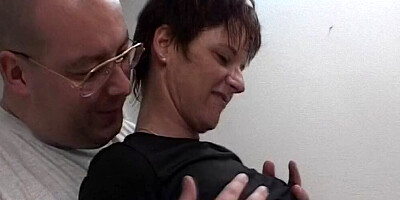 Mature woman smiles at the camera while playing with that cock