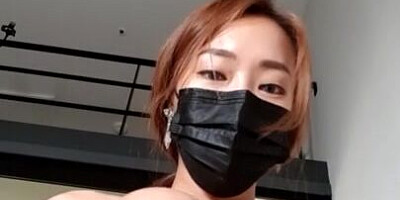 Busty Asian lady is posing in sexy lingerie while wearing a surgical mask