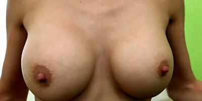 Busty brunette MILF flirts with the camera while riding cock