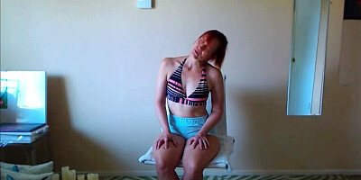 Lovely redheaded amateur babe is posing in front of the cam