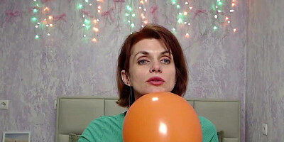Redhead Milf plays with balloon on webcam