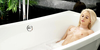 Beautiful young blonde masturbates in a bath before being dicked down
