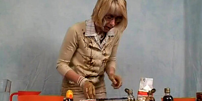 Kinky mature woman rubs herself with some chocolate in the kitchen