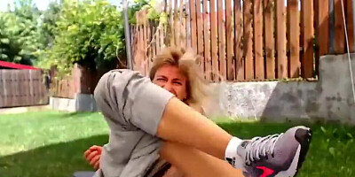 Slutty MILF wears a butttplug while rubbing pussy in the yard