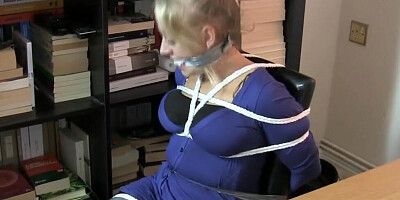 Secretary is being tightly roped and duct-taped by a kinky masked man