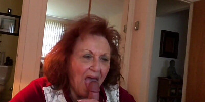 Red-haired granny with huge tits blows and fucks a guy