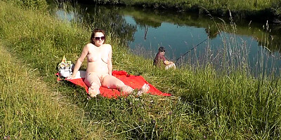 Nudist beach. Public nudity. Naked in public. Sexy MILF without panties and bra sunbathes naked Nude