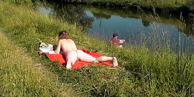 Nudist beach. Public nudity. Naked in public. Sexy MILF without panties and bra sunbathes naked Nude