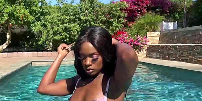 Delightful ebony model Ana Foxxx gets nude and plays in a swimming pool