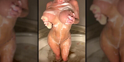 Curvaceous British minx Sophie Dee is playing with her big boobs while taking a bath