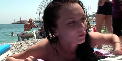 Brunette girl seduces a guy at the beach and invites him over