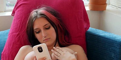 Cute emo babe is browsing the mobile phone while cumming