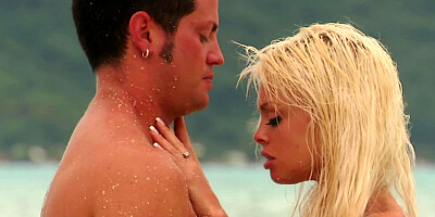 A blonde is at the beach and she is receiving a big dick in her face