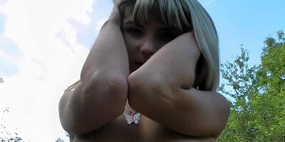 A chick with tiny nipples is getting naked while out in public