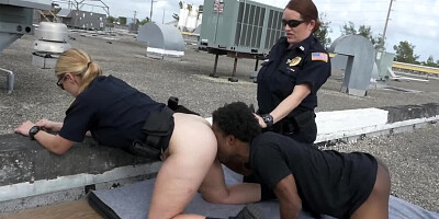 Black stud and two female cops are fucking on the roof